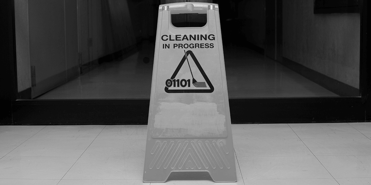 A janitor's sign showing a mop and warning that cleaning is in progress.
